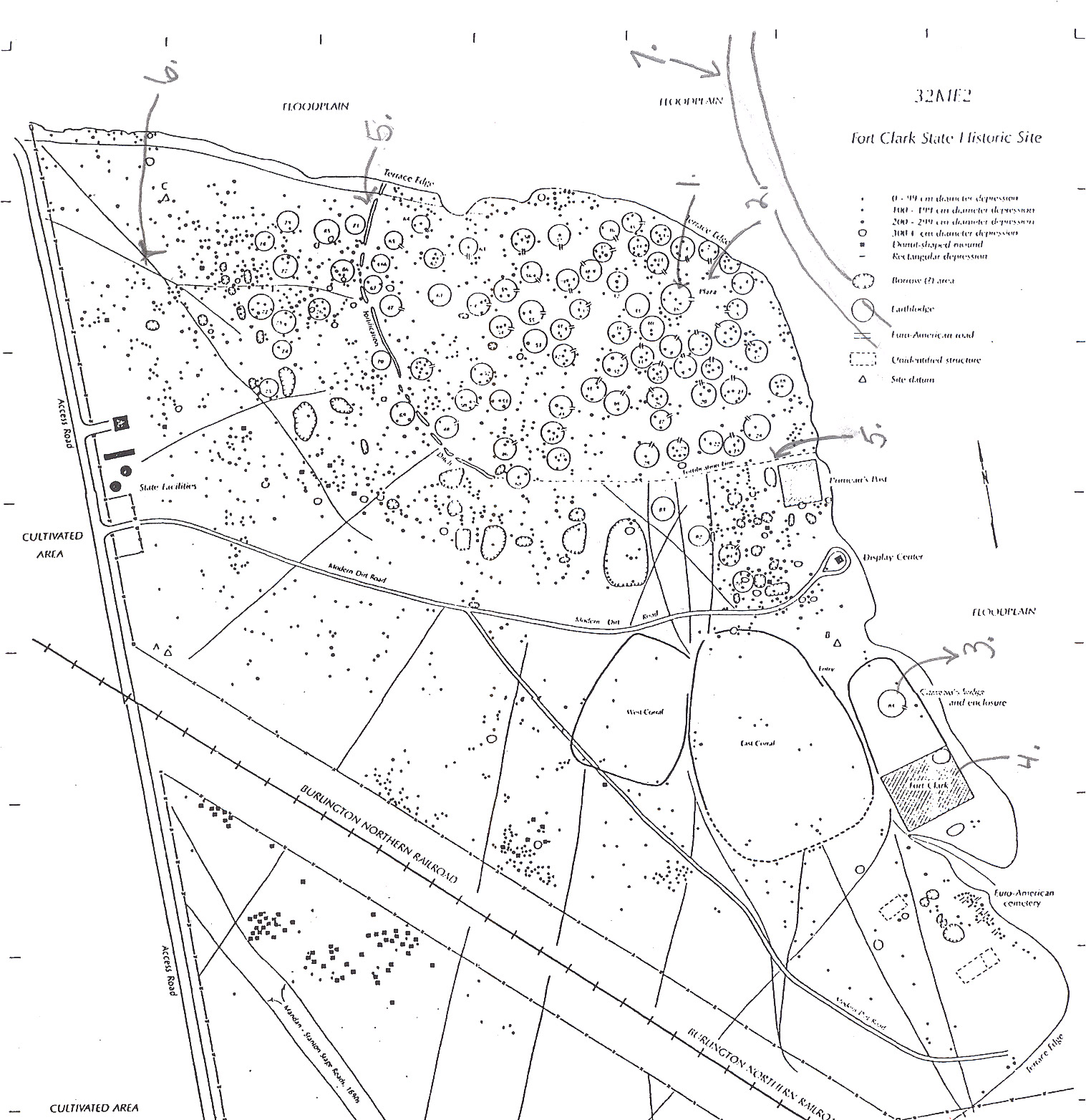 Archaeologist Raymond Wood made this drawing of the remains of Fort Clark and the nearby Mandan village.  In the lower right corner, the shaded rectangle shows the location of Fort Clark.  The small circle just above (north ) was the site of Pierre Garreau’s lodge.  Garreau was the son of a French fur trader and a Mandan woman.  He lived in the Mandan style.  The circles are the sites of lodges in the village.  The village ceremonial lodge (No. 1) and the village plaza (No. 2) were located close to the river bank.  The village, called Mitu’tahakto’s (meh Toot ah hang tosh), was built in 1822 with a palisade wall (No. 5) for protection.  Trails were dug into the earth by travois poles dragging behind horses.  The trails are still visible (No. 6).