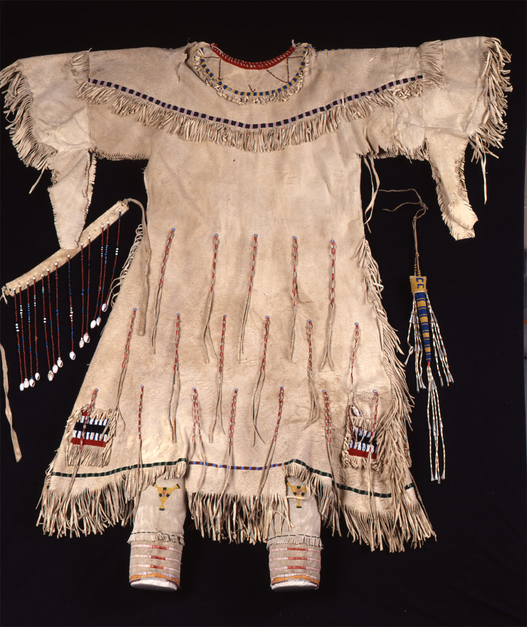 “Young woman’s buckskin dress, owned by Spotted Crow Woman.”   This dress was made by Spotted Crow Woman.  A few years later, Mink (Hannah Leavings Grant) wore this dress when she posed for the statue of Sakakawea that now stands in front of the State Historical Society of North Dakota Heritage Center.  The dress was the most highly valued item in the collection at $85. SHSND Museum 01442
