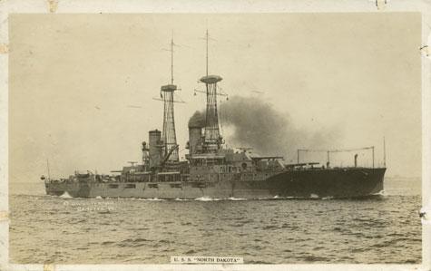 A large battleship sits out in the water.