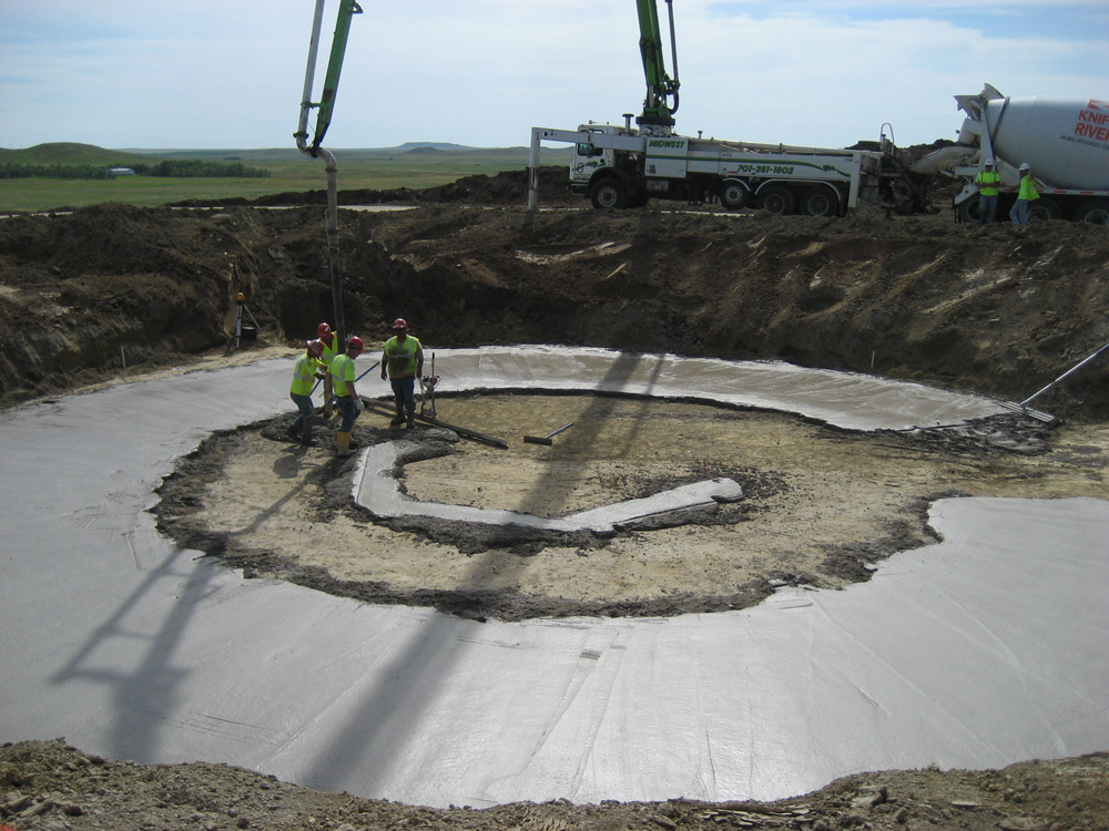 Cement is poured for the wind tower foundation.