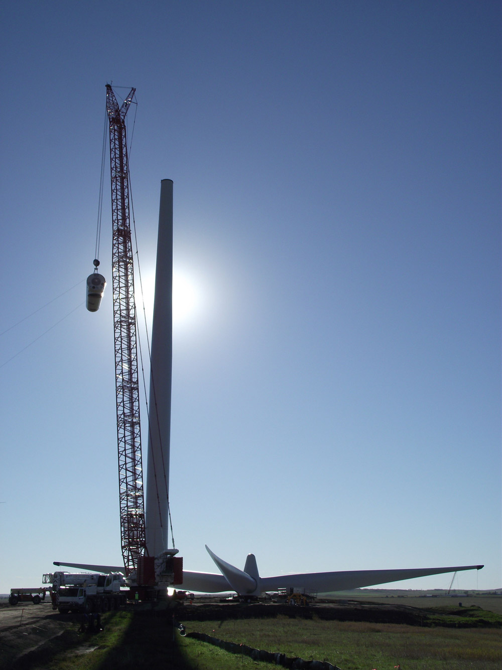 The rest of the tower is connected and the nacelle lifted to the top of the tower by a crane.