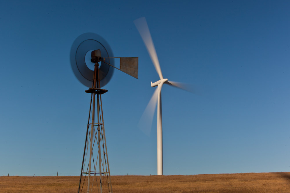 Image 1: An old windmill stands next to the modern version. Early versions of windmills pumped water for <u>household use</u> and to fill water tanks for <u>livestock</u>. Modern windmills are used to generate electricity.