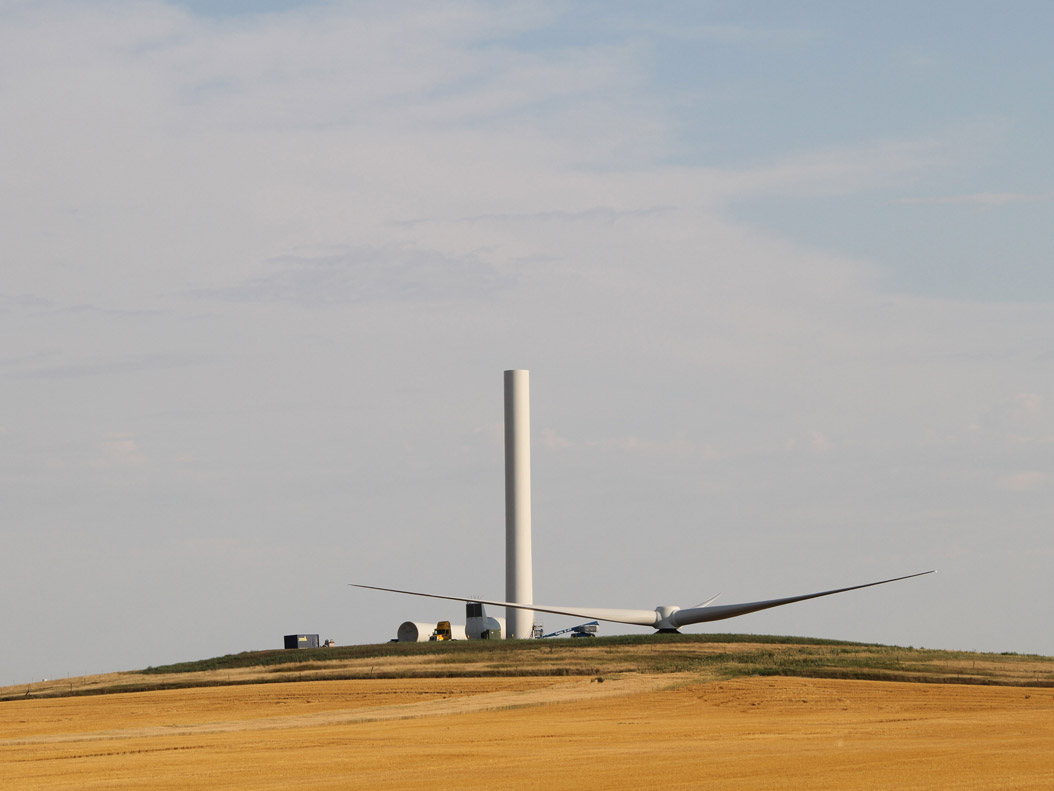 Bison 4 – The nacelle is fastened and the blades are connected on the ground. A <u>nacelle</u> (nah-SEL) is the structure behind the blade of a wind turbine that holds the drive shafts, gear box, and generator.
