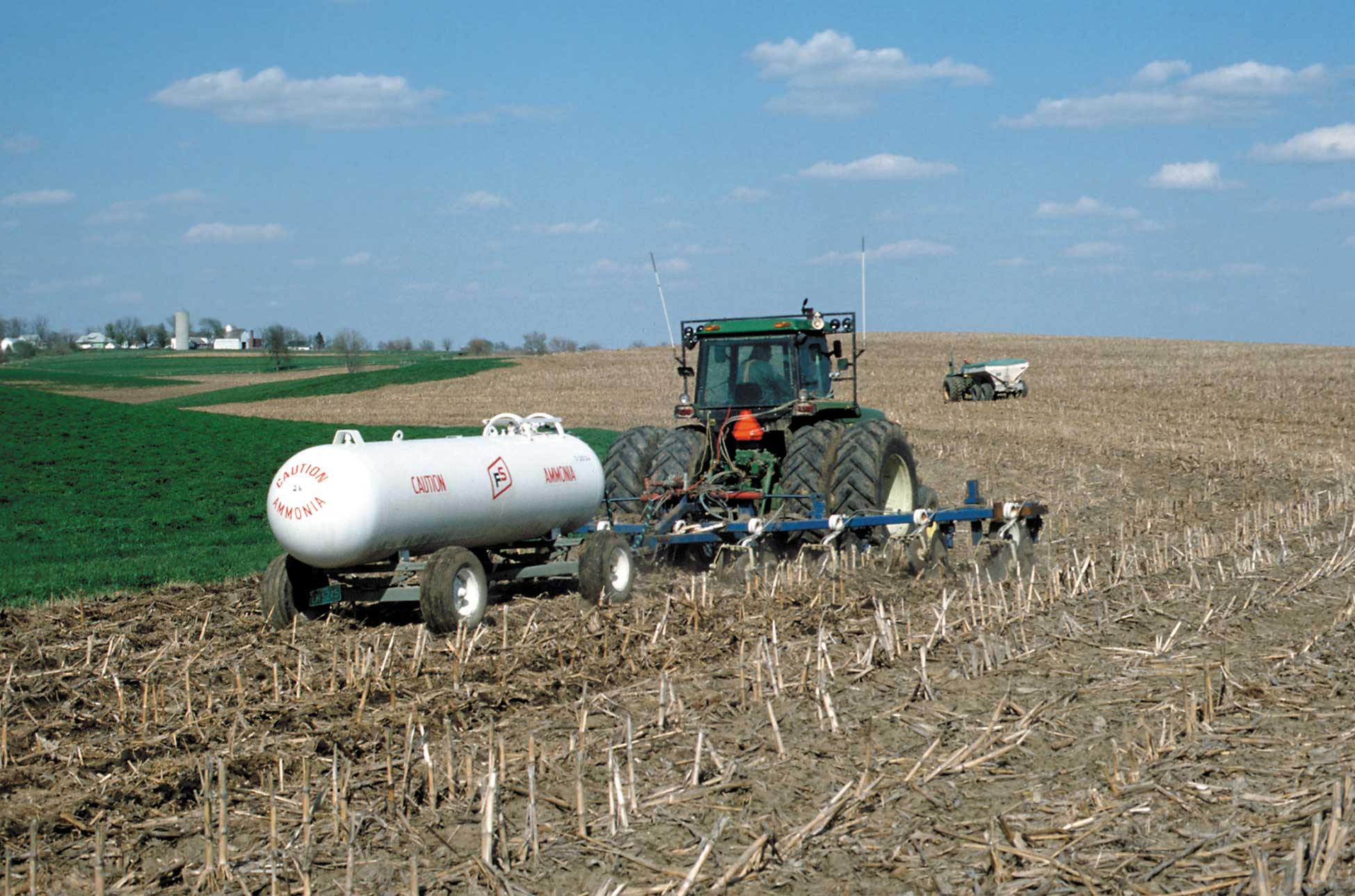 Figure 151. This farmer is applying liquid fertilizer