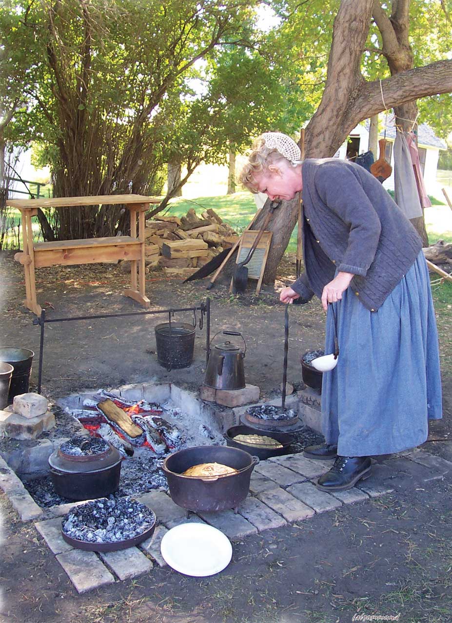 Figure 38. This woman demonstrates the art of pioneer cooking