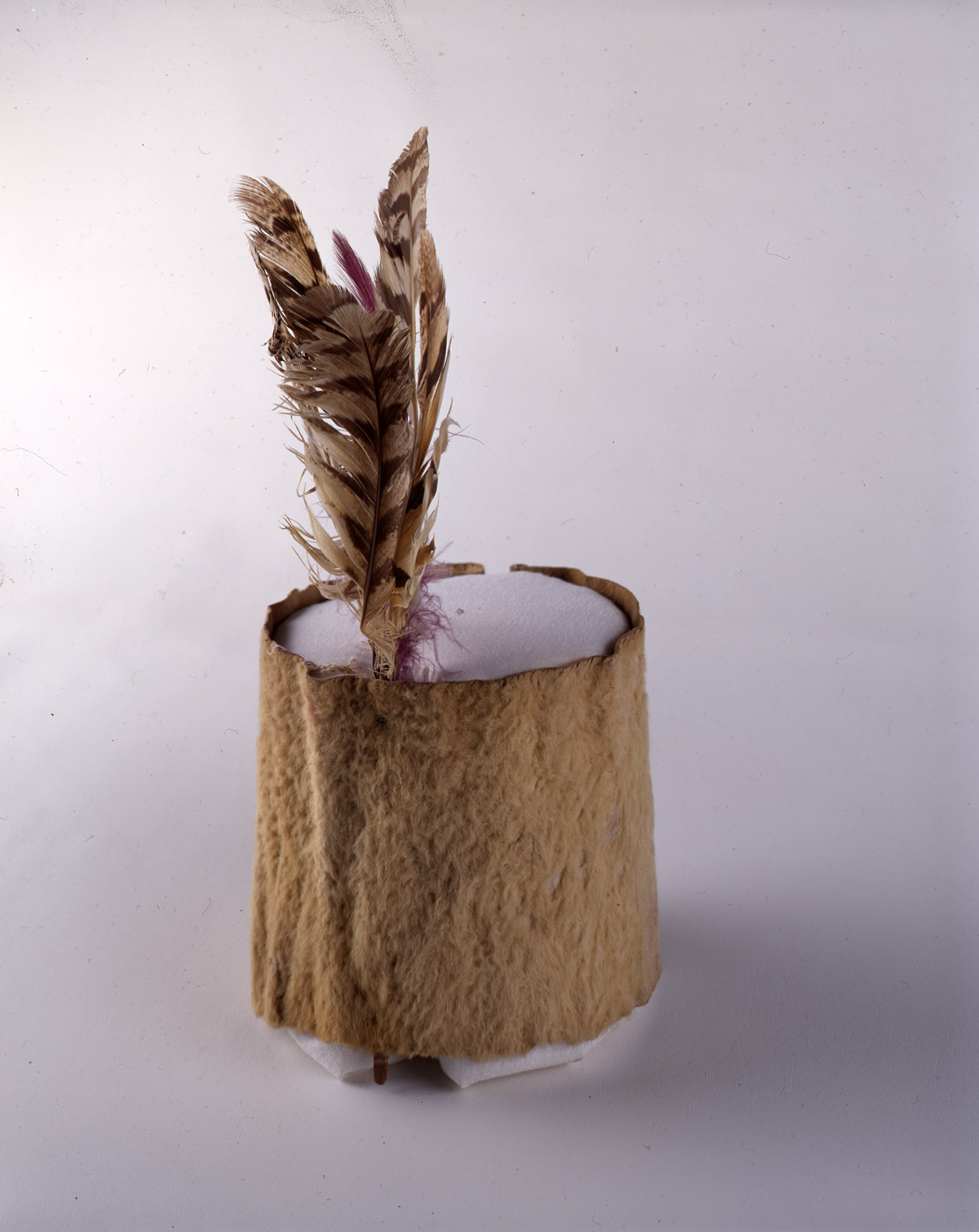 Woman’s White Buffalo Skin Headdress, owned by Cherry Woman.”  This simple headdress was made from a piece of hide from a white buffalo.   Bison with white hair occurred naturally in the wild herds of the northern Great Plains.  This headdress would have been worn by a woman when she participated in the rituals of her society.   The headdress was valued at $75 in 1907. SHSND Museum 00585