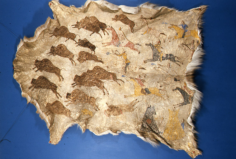 “Painted Deerhide, owned by Birds Bill.”  This pictograph, painted on the inner side of a tanned deerhide shows several Indians, probably of the Mandan, Hidatsa, or Arikara tribes, hunting bison with a non-Indian guest who was identified as Buffalo Bill Cody.  The hide was owned, and probably painted by Birds Bill.  Birds Bill was a Hidatsa who was 34 years old in 1906.  The hide was valued at $40 in 1907. SHSND Museum 01100