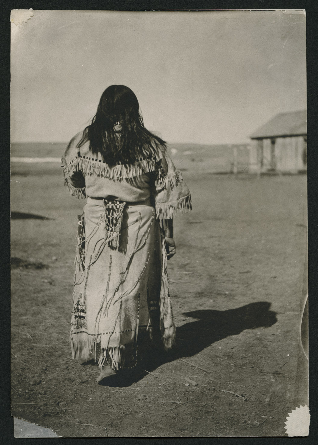 Hannah Leavings wore the buckskin dress while posing for the sculptor Leona Crunelle. If you visit the Heritage Center in Bismarck, you can see the details on the statue that correspond to the dress in this photograph. SHSND A4418