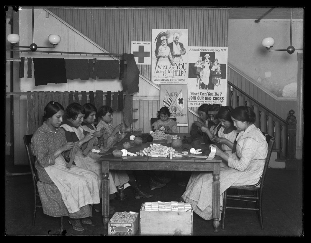 Women and girls knitted and rolled bandages for soldiers at a Red Cross workshop at Fort Yates on the Standing Rock Reservation.