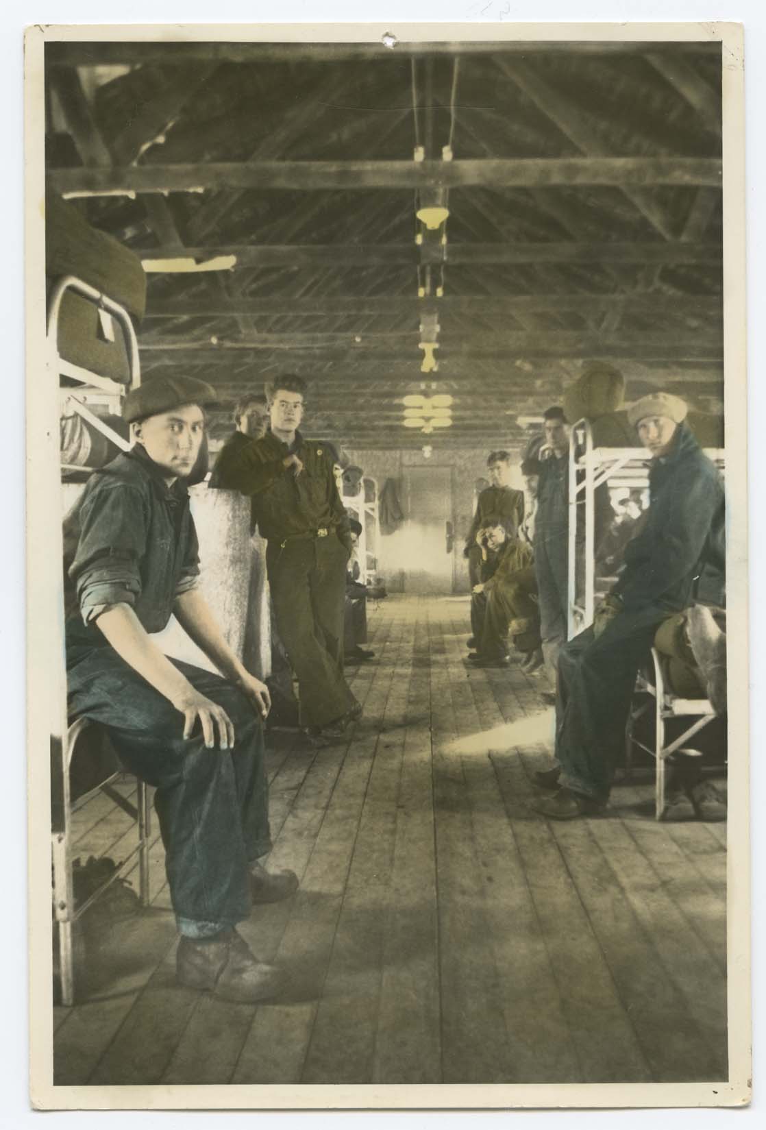 Members of the Civilian Conservation Corps (CCC) Camp 794 in barracks at International Peace Garden (Man. and N.D.). Man closest to camera is Harold Archers, other men unidentified