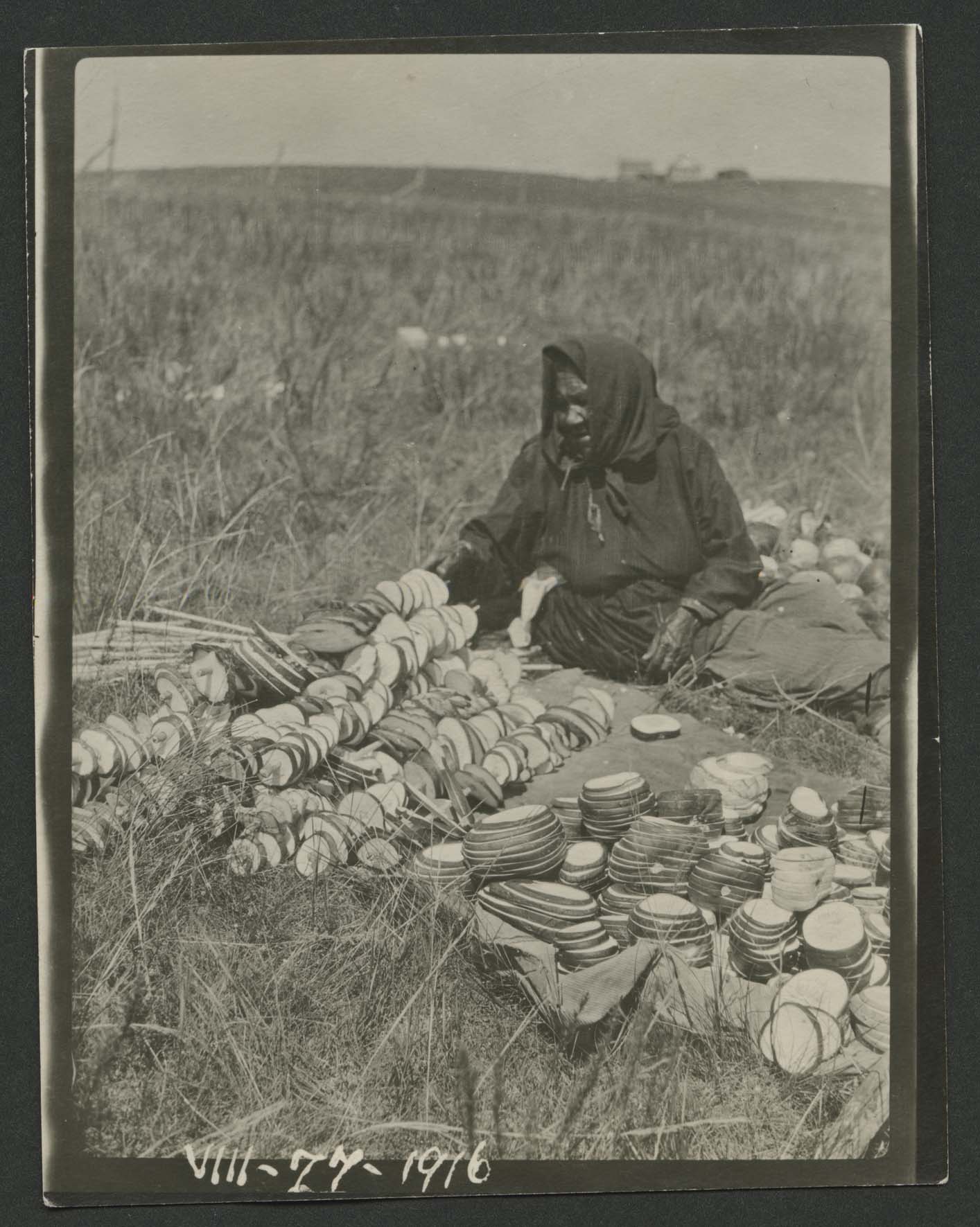 Owl Woman surrounded by neatly sliced squash.