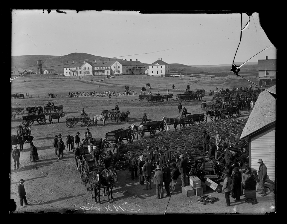 Plow Issue with Indian boarding school in the background Standing Rock Indian Reservation, Fort Yates, Sioux County