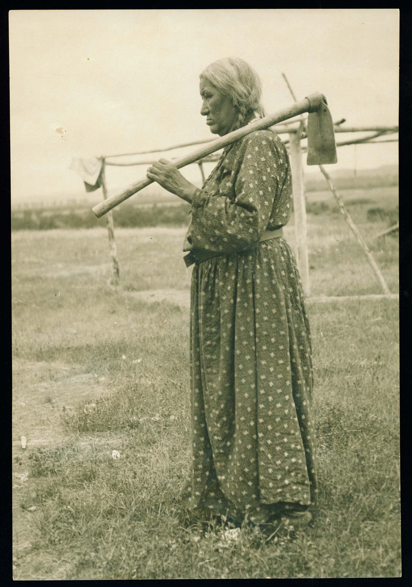 Scattered Corn standing with hoe.