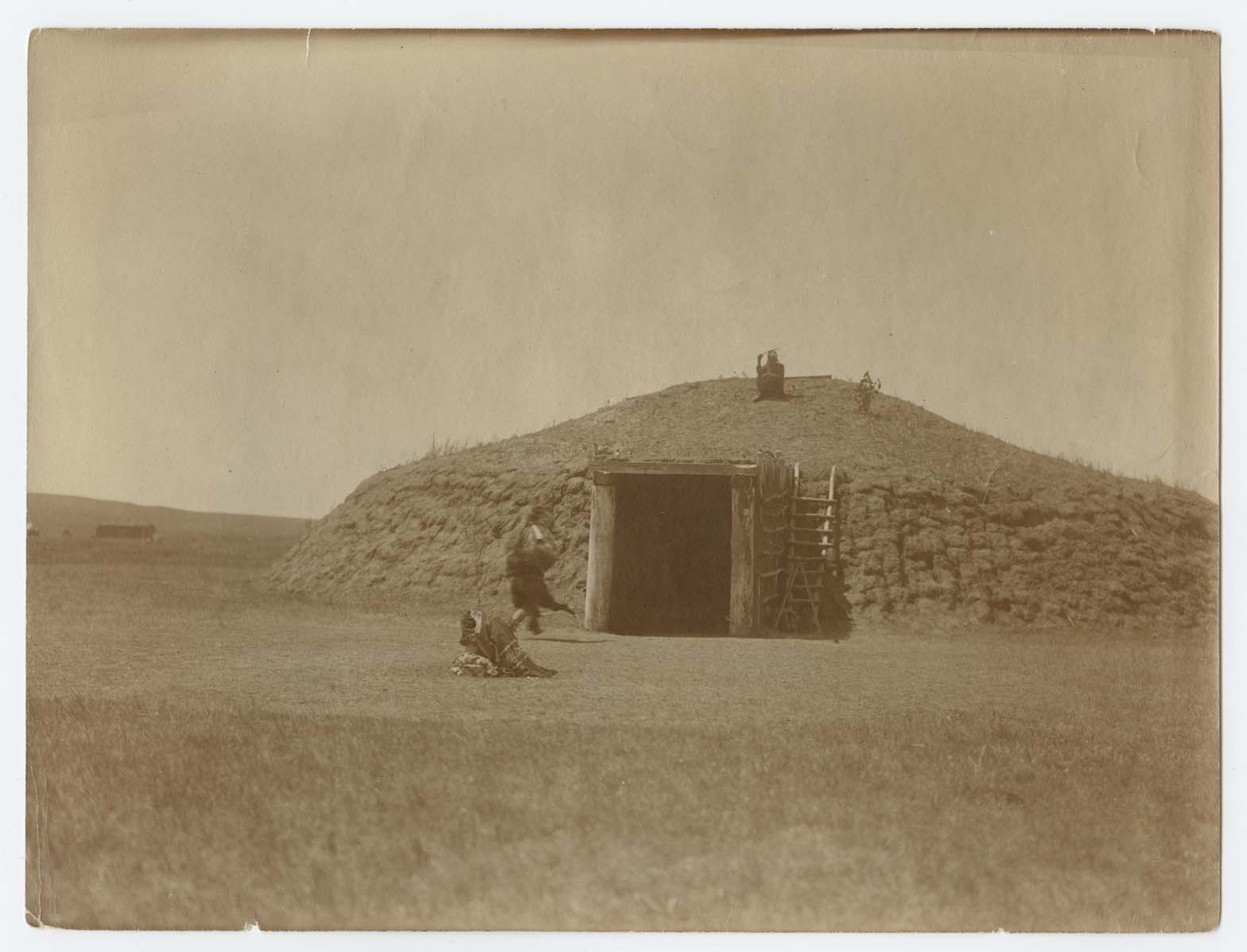 The Bear emerges from an Arikara medicine lodge during a ceremony