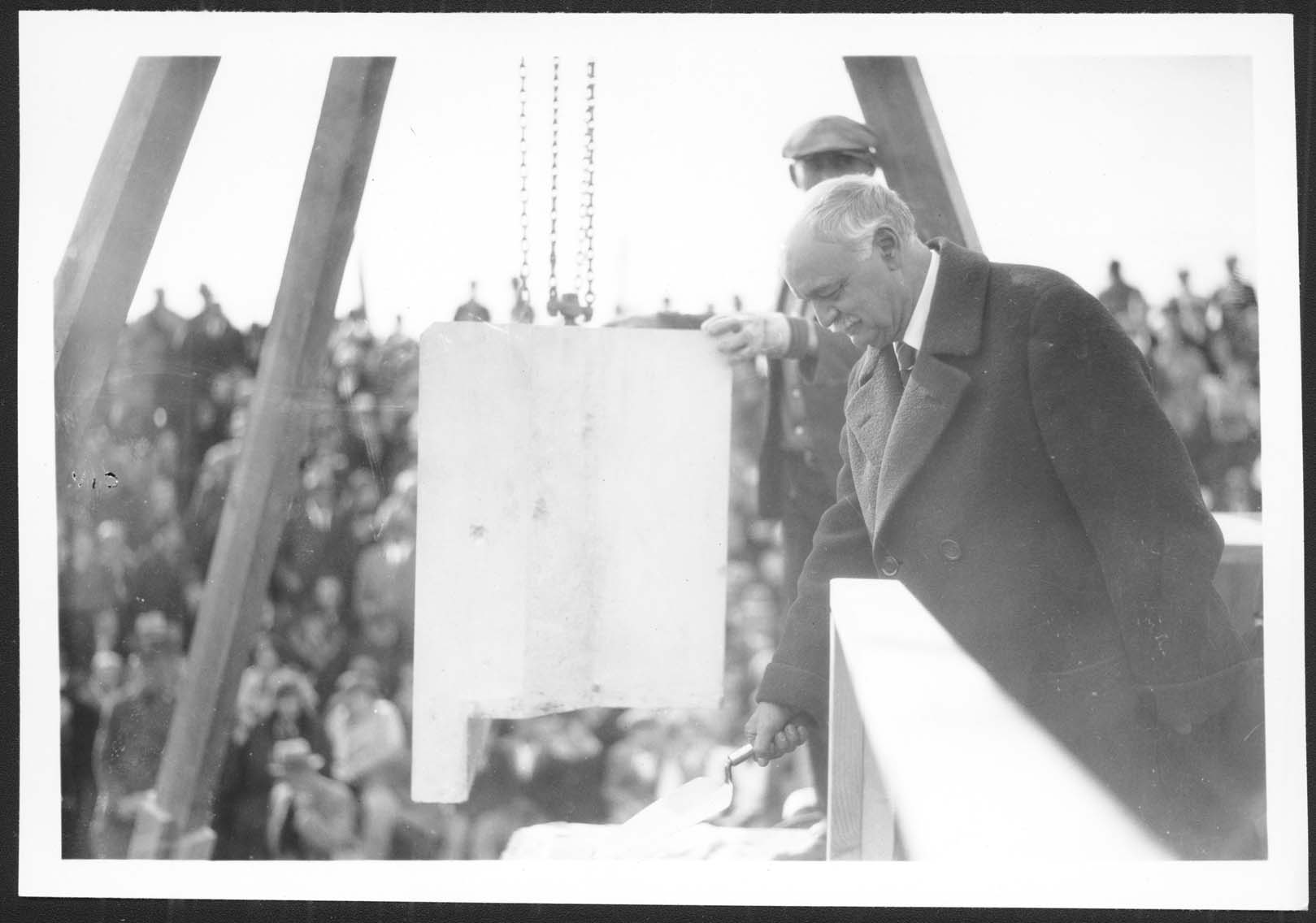 Vice President Charles Curtis places mortar under the cornerstone