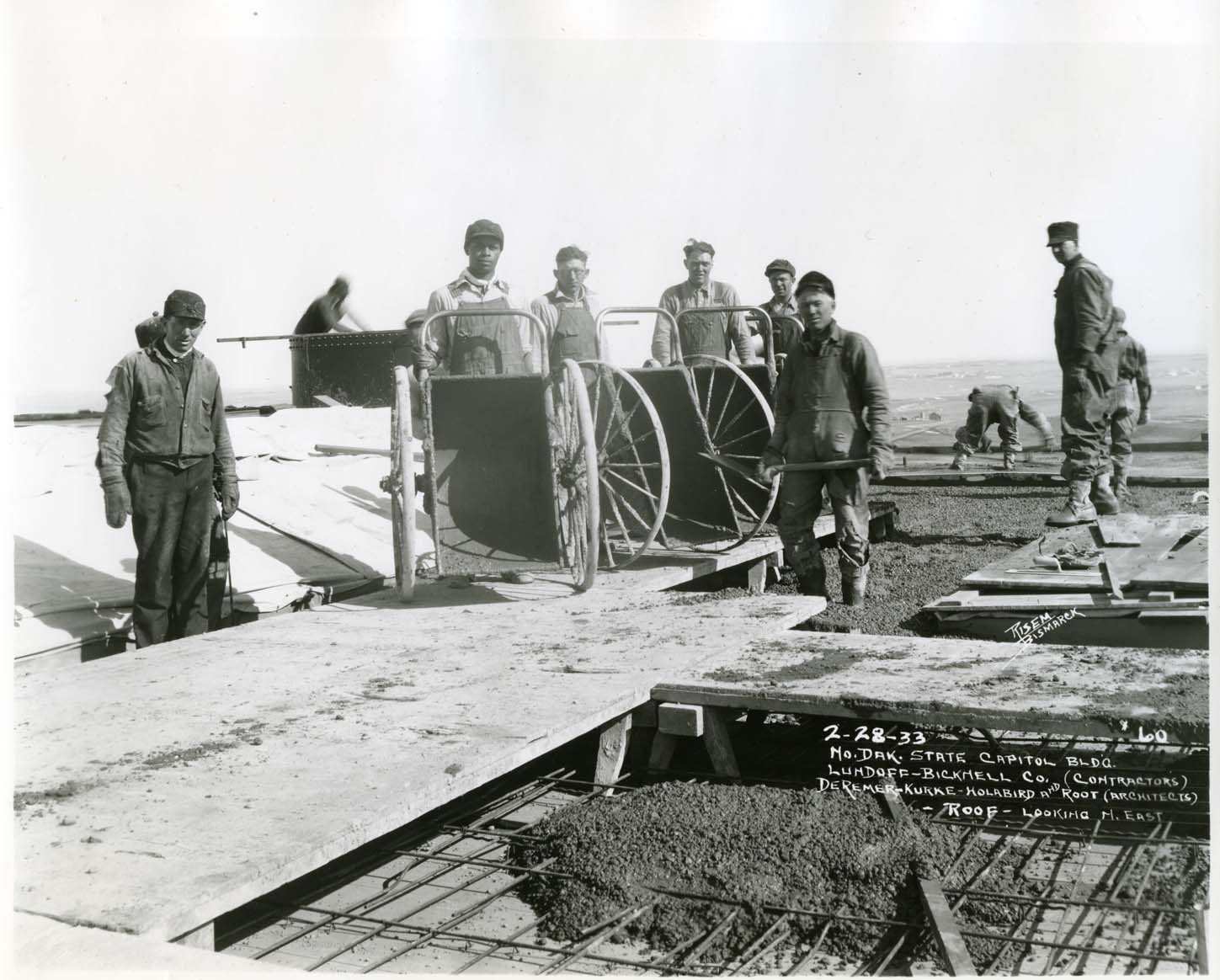 common laborers pour cement on the capitol roof