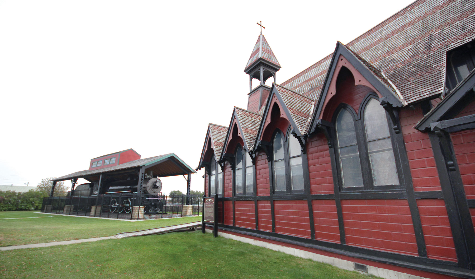 red and black building with a black train engine in the background.