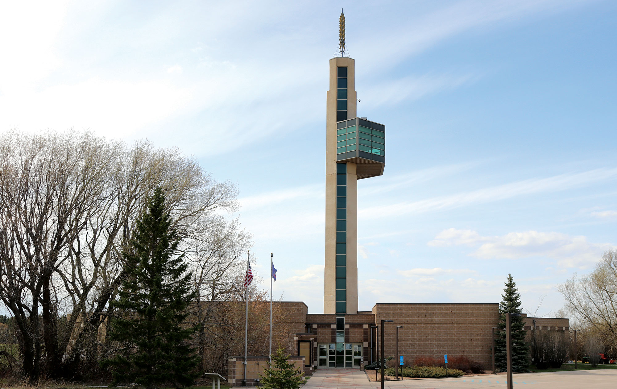the exterior of a brick building is shown with a tall tower coming up from the middle of it